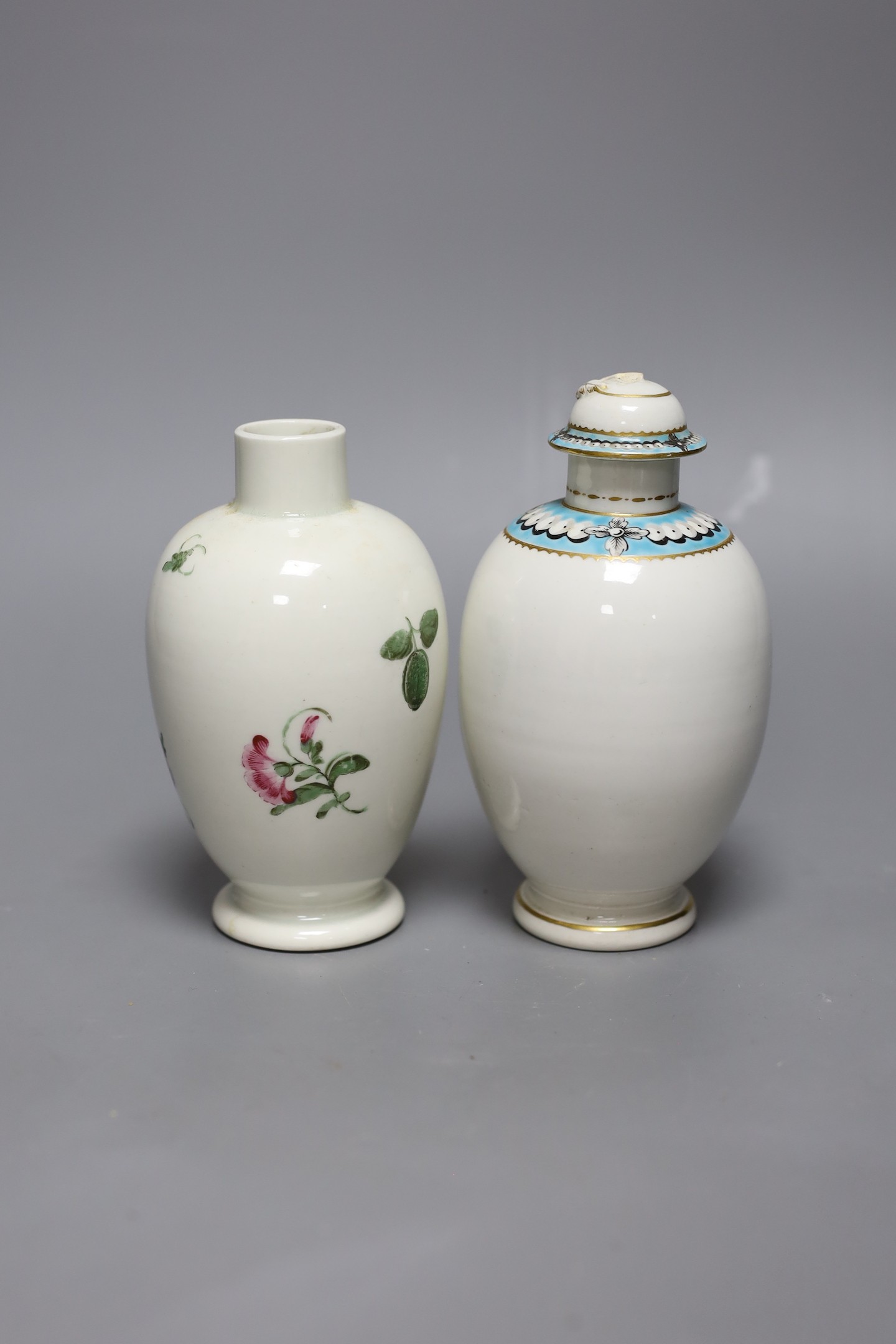 A Worcester tea canister and cover painted with ‘pearls’ in a turquoise band and another Worcester tea canister painted with flowers, 15 cms high including cover